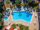 Aerial view of a sparkling community pool and lounge area, perfect for relaxation and social gatherings at 1162 Carmel Cir # 440, Casselberry, FL 32707