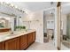 Bathroom featuring a double sink vanity, large mirror, and a separate toilet and shower area at 1162 Carmel Cir # 440, Casselberry, FL 32707