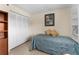Bedroom showcasing a twin bed, built-in shelving, and a closet for storage, offering a comfortable and functional space at 1162 Carmel Cir # 440, Casselberry, FL 32707