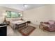 Spacious bedroom featuring a comfortable bed and a cozy sitting area at 1162 Carmel Cir # 440, Casselberry, FL 32707
