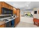 Efficient kitchen with wood cabinets and easy access to dining and living areas at 1162 Carmel Cir # 440, Casselberry, FL 32707