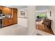 Open kitchen with wood cabinetry seamlessly connects to living area with lots of light at 1162 Carmel Cir # 440, Casselberry, FL 32707