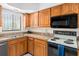 Well-equipped kitchen with oak cabinets and granite countertops for easy meal preparation at 1162 Carmel Cir # 440, Casselberry, FL 32707