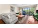 Cozy living room features a comfortable couch, area rug, and balcony with green views at 1162 Carmel Cir # 440, Casselberry, FL 32707