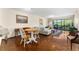 Inviting living room with hardwood floors and balcony access showcasing nature views at 1162 Carmel Cir # 440, Casselberry, FL 32707