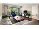Bright living room with large glass doors to balcony with views of green trees and foliage at 1162 Carmel Cir # 440, Casselberry, FL 32707