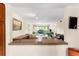 Open living space featuring kitchen bar, dining, and living areas with natural light at 1162 Carmel Cir # 440, Casselberry, FL 32707