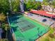 Overhead shot of the community tennis court and surrounding amenities, including parking and red tile roofs at 1162 Carmel Cir # 440, Casselberry, FL 32707