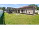 Expansive backyard with lush green lawn, screened lanai, and beautiful outdoor living space at 12614 Hawkstone Dr, Windermere, FL 34786