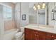 Bathroom with a single vanity, granite countertops, bathtub/shower combo, and decorative lighting at 12614 Hawkstone Dr, Windermere, FL 34786