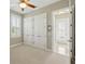 Clean bedroom featuring neutral carpet, plantation shutters, double closet and abundant light from an open doorway at 12614 Hawkstone Dr, Windermere, FL 34786