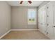 Bedroom with window and plantation shutters has ample closet space and neutral carpet at 12614 Hawkstone Dr, Windermere, FL 34786