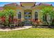Inviting home entrance with double doors, complemented by colorful plants and manicured lawn at 12614 Hawkstone Dr, Windermere, FL 34786
