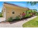 Well-maintained home exterior with lush landscaping, a paved walkway, and lovely architectural details at 12614 Hawkstone Dr, Windermere, FL 34786
