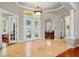 Spacious foyer with double entry doors with decorative glass inserts and arched openings to other rooms at 12614 Hawkstone Dr, Windermere, FL 34786