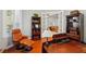 Well appointed home office with hardwood floors, leather chair and footstool, and built-in bookcase at 12614 Hawkstone Dr, Windermere, FL 34786