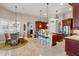 Open-concept kitchen and dining area with stylish chandelier and ample seating at 12614 Hawkstone Dr, Windermere, FL 34786