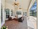 Spacious covered lanai featuring ample seating, ceiling fans, and stylish brick flooring at 12614 Hawkstone Dr, Windermere, FL 34786