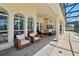 Inviting lanai with comfortable seating, arched windows, and direct access to the pool area at 12614 Hawkstone Dr, Windermere, FL 34786