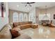Bright living room with a comfortable sectional sofa and elegant arched windows at 12614 Hawkstone Dr, Windermere, FL 34786