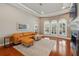 Bright living room with fireplace, leather sofa, and elegant rug at 12614 Hawkstone Dr, Windermere, FL 34786