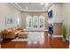 Elegant living room with a cozy leather sofa, fireplace, and ample natural light at 12614 Hawkstone Dr, Windermere, FL 34786
