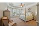 Tranquil main bedroom with a four-poster bed and abundant natural light at 12614 Hawkstone Dr, Windermere, FL 34786