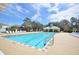 Community pool with clear blue water, lounge chairs, and a cabana, perfect for relaxing and enjoying the outdoors at 12614 Hawkstone Dr, Windermere, FL 34786