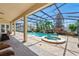 Tropical paradise: Screened-in pool and spa, complete with lush landscaping and a relaxing ambiance at 12614 Hawkstone Dr, Windermere, FL 34786
