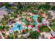 Aerial view showcasing the community's multiple pools, palm trees, and lush landscaping at 130 Palermo St, Davenport, FL 33897