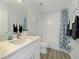 Bright bathroom featuring a tub with shower and a vanity with white cabinets and a granite countertop at 130 Palermo St, Davenport, FL 33897