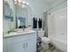 Well-lit bathroom with white vanity, modern fixtures, and a shower-tub combination at 130 Palermo St, Davenport, FL 33897