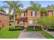 Attractive two-story townhome with brick-paved driveway and manicured front yard at 130 Palermo St, Davenport, FL 33897