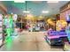 Bright game room with colorful arcade games and a fun play structure for children at 130 Palermo St, Davenport, FL 33897