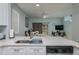 Open-concept kitchen with stainless dishwasher, modern countertops, and view to living area at 130 Palermo St, Davenport, FL 33897
