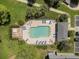 Aerial shot of a fenced community pool, deck, lounge chairs, and landscaping at 131 Heritage Park St, Winter Springs, FL 32708