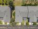 An aerial view shows the rooftops and parking areas of townhomes surrounded by well-maintained greenery, trees, and landscaping at 131 Heritage Park St, Winter Springs, FL 32708