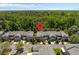 Aerial view of townhomes surrounded by lush greenery showcasing the home's location and landscaping at 131 Heritage Park St, Winter Springs, FL 32708