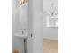 Clean half bathroom with a pedestal sink and a decorative light fixture at 131 Heritage Park St, Winter Springs, FL 32708
