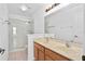 Bathroom with a double sink vanity, a large mirror, and a glass-enclosed shower at 131 Heritage Park St, Winter Springs, FL 32708