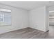 Bright bedroom featuring wood-look floors, white walls and a window providing natural light at 131 Heritage Park St, Winter Springs, FL 32708