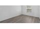 Bright bedroom featuring wood-look floors and a window with white blinds at 131 Heritage Park St, Winter Springs, FL 32708