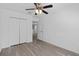Bedroom with wood-look flooring, features double closet and neutral walls at 131 Heritage Park St, Winter Springs, FL 32708