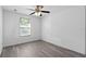 Bedroom featuring wood-look flooring, neutral walls and a window with a ceiling fan at 131 Heritage Park St, Winter Springs, FL 32708