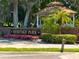 Entrance to Heritage Park, featuring brick signage with manicured flower beds and palm trees at 131 Heritage Park St, Winter Springs, FL 32708