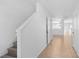 Bright hallway with tile flooring leading to the living spaces and staircase at 131 Heritage Park St, Winter Springs, FL 32708