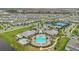 Aerial view of the community clubhouse with pool and tennis courts in a suburban neighborhood at 13640 Haulover Beach Ln, Orlando, FL 32827