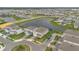Aerial view of homes and lush landscaping in a well-planned community with a lake and walking trails at 13640 Haulover Beach Ln, Orlando, FL 32827