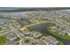 Aerial view of a suburban community with well-manicured lawns and water features at 13640 Haulover Beach Ln, Orlando, FL 32827