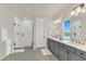 Modern bathroom with double vanity, walk-in shower, and contemporary finishes at 13640 Haulover Beach Ln, Orlando, FL 32827